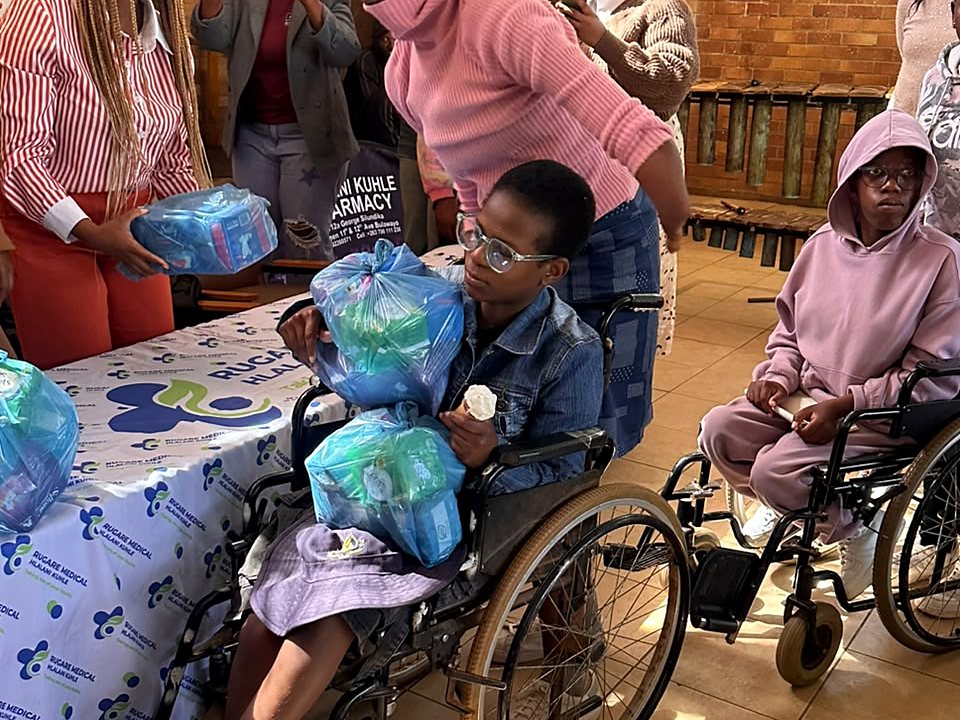 A wheelchair user receiving practical support at a community event