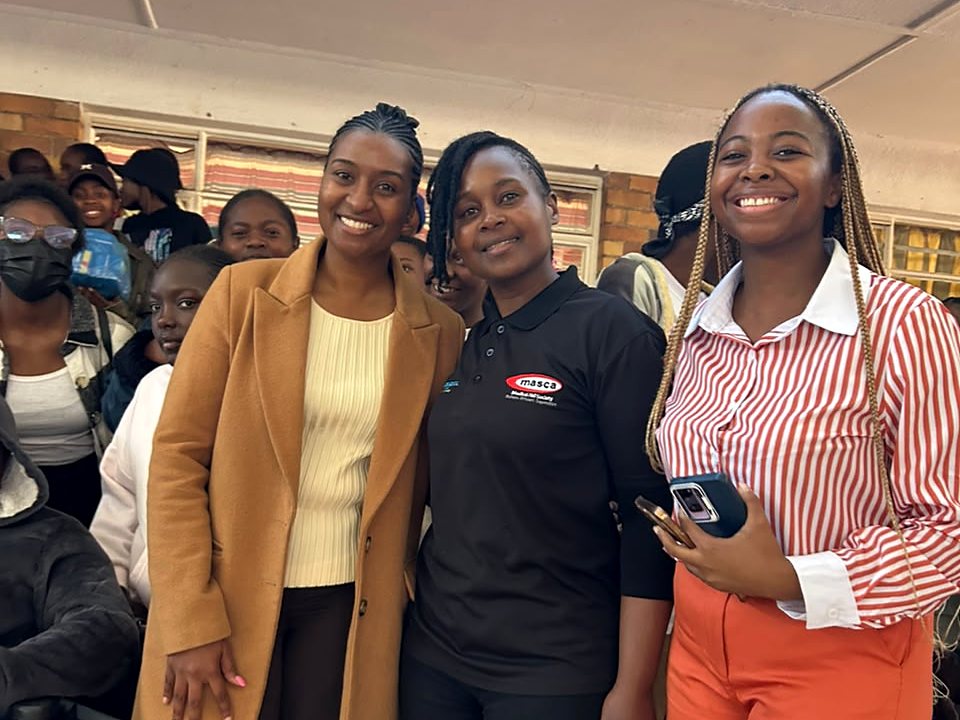 Three women representing partner teams at a community gathering