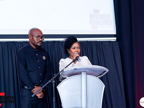 Two speakers addressing an audience during a health advocacy event