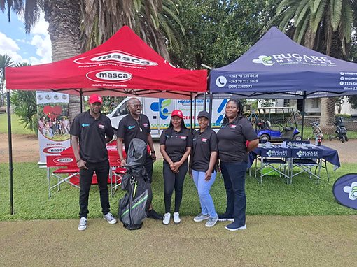 Rugare representatives and partner team members beside community health stands