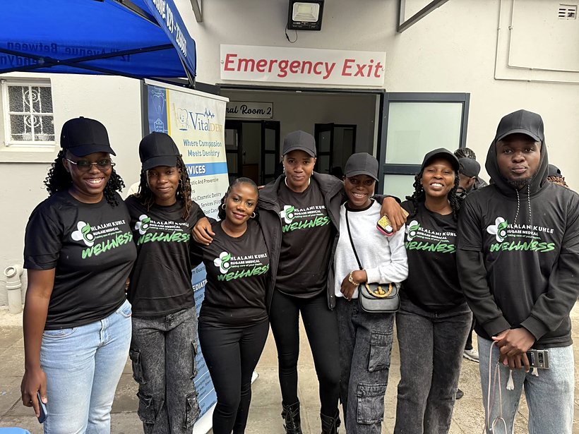 Rugare team members together outside the medical facility during a wellness activity