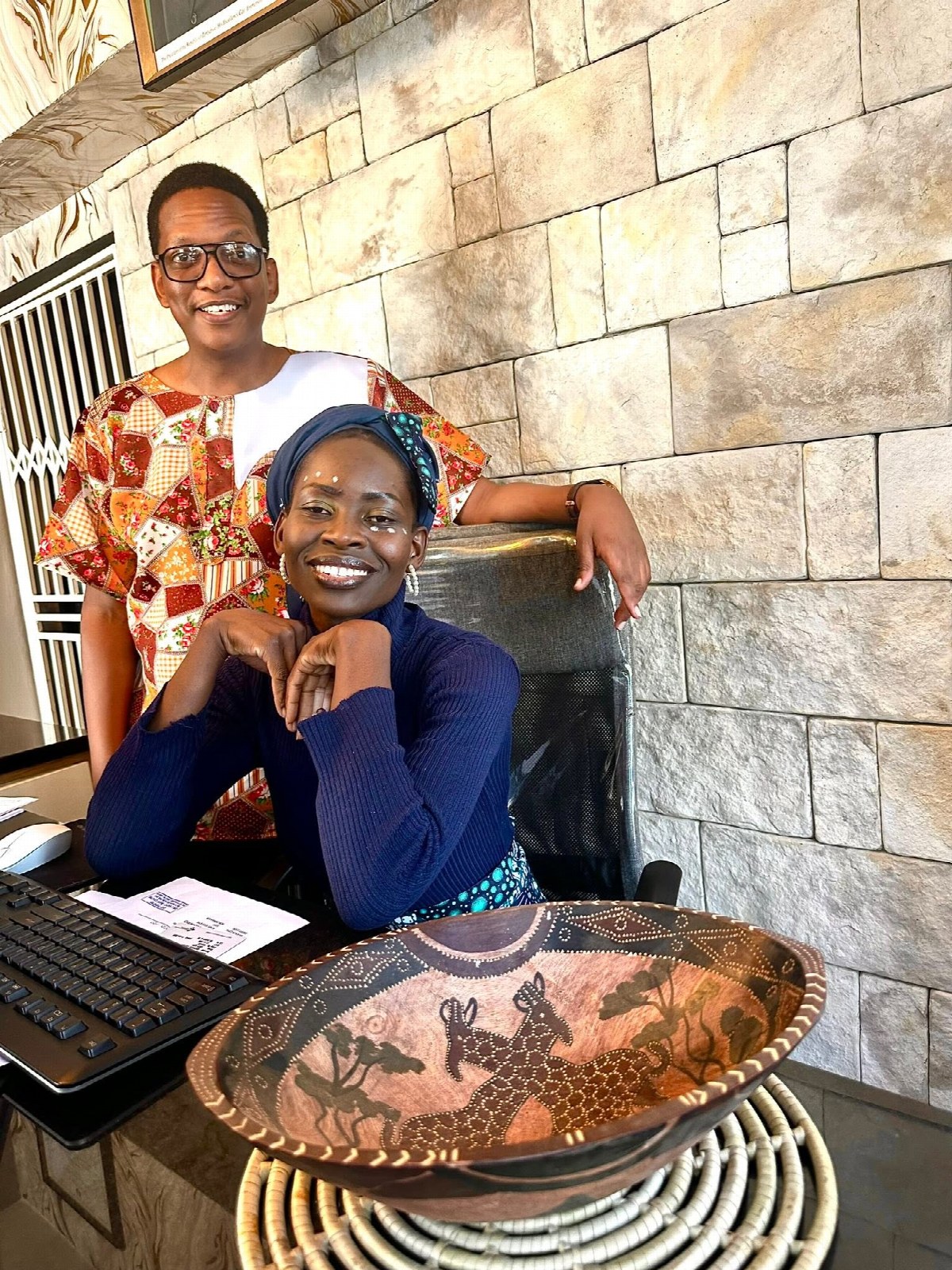 Two smiling Rugare Medical team members in the office