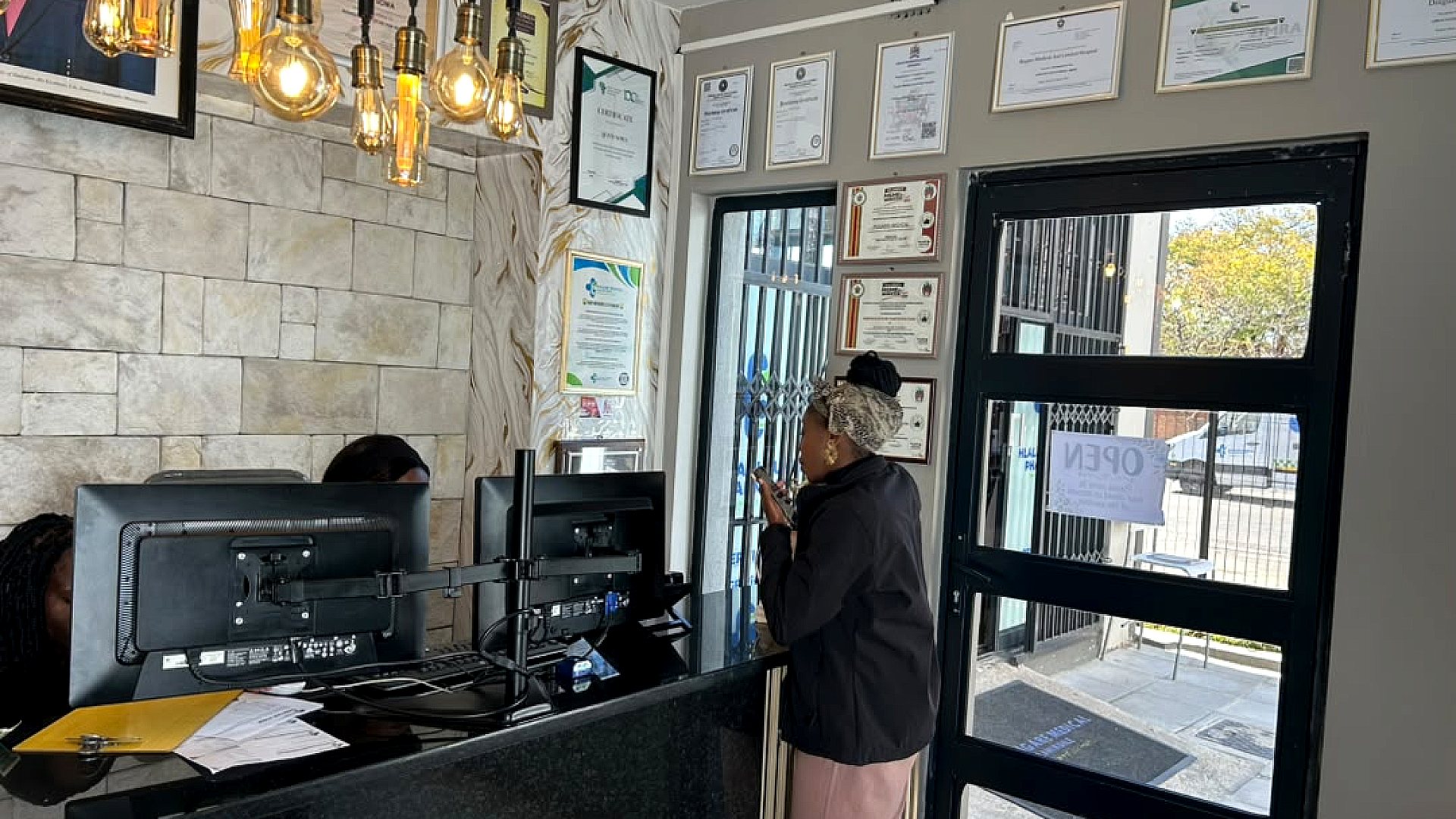 A visitor speaking with the Rugare Medical reception team