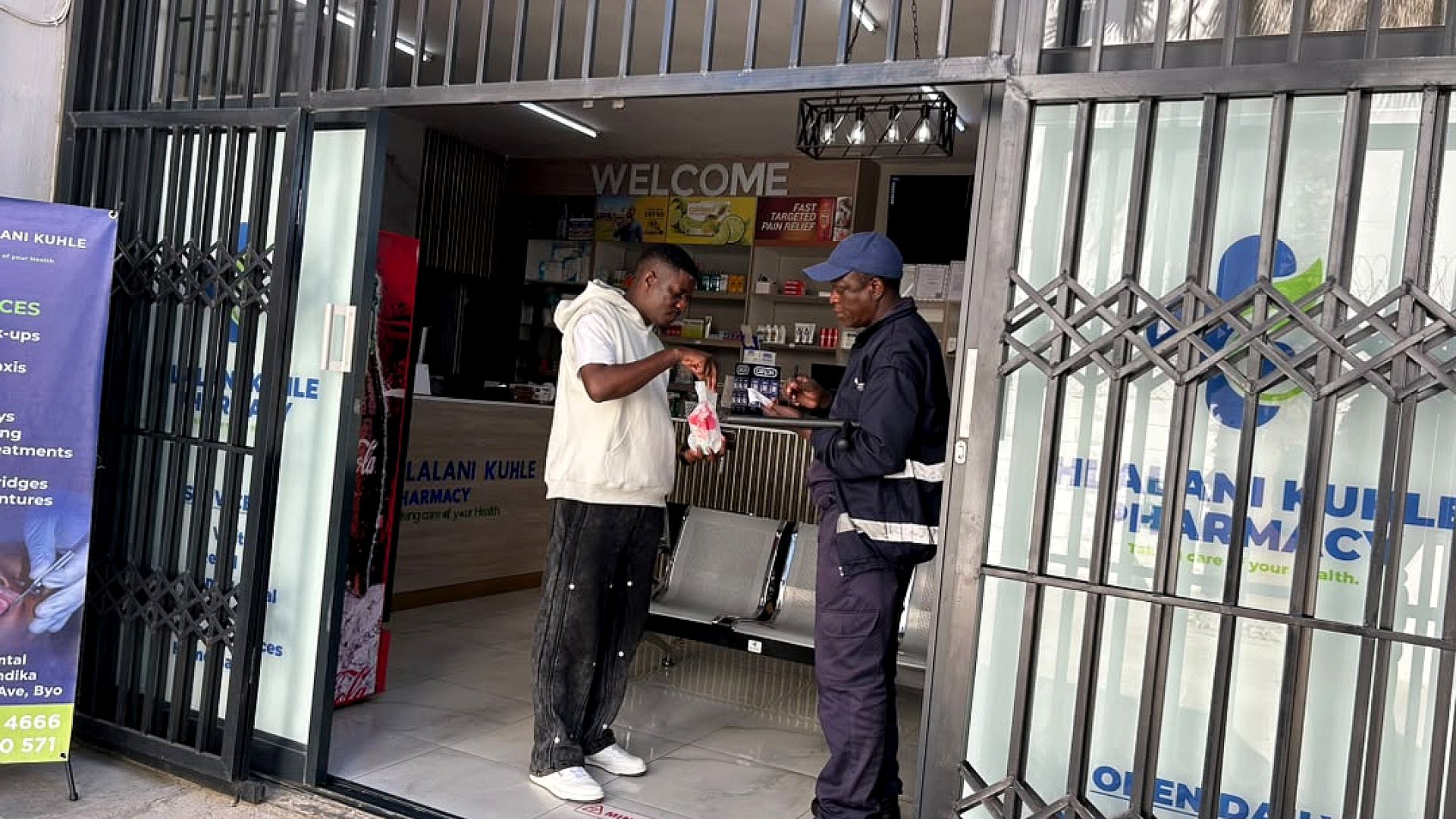 A customer receiving assistance at the Hlalani Kuhle Pharmacy entrance